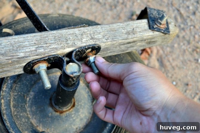 unscrew wheelbarrow bolts to release tire