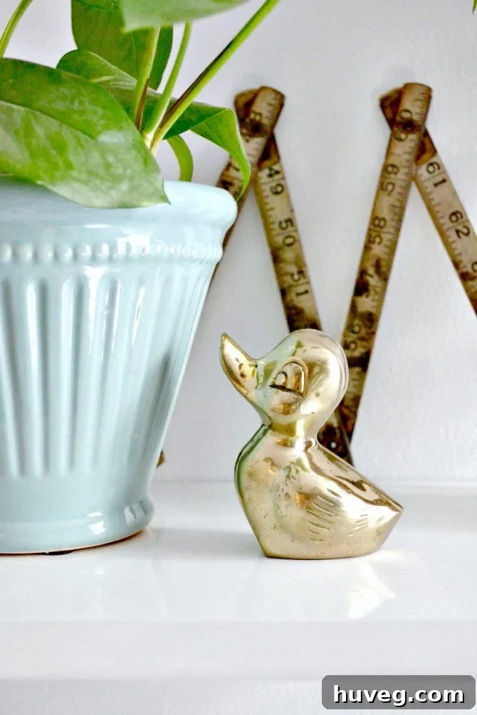 Brass duckling paperweight on a desk in a home office, symbolizing focus and organization in remote work.