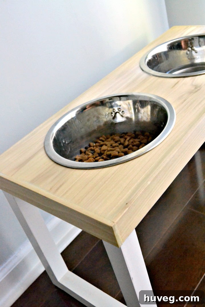 From the side, you can see the wood grain finish on the top of my non-slip dog feeder with white legs. 