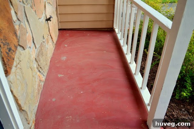 Close-up of the red front stoop, highlighting the color clash with the updated house.