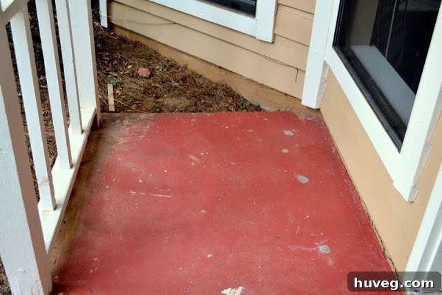 View of the front door and red stoop, emphasizing the visual disconnect.