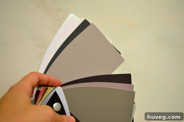 Painter's tape marking uneven spots on a wall for sanding.