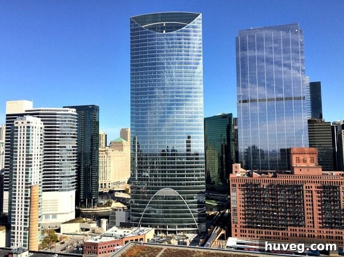 Curved building reflecting the Chicago River