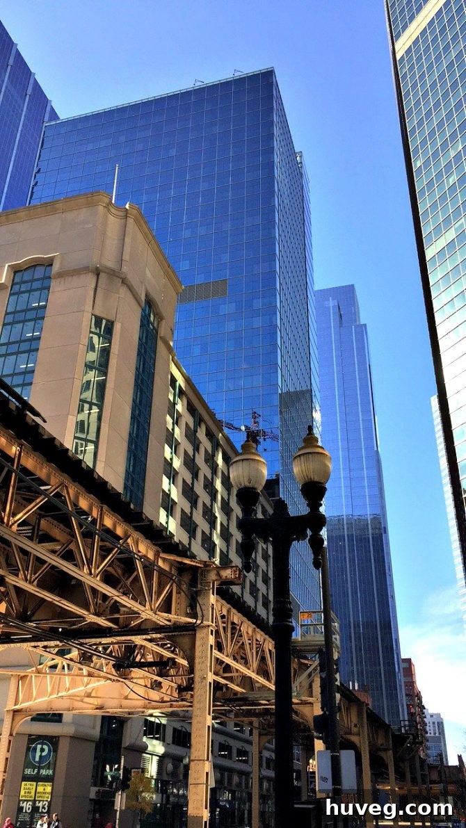 Chicago L train tracks against modern skyline