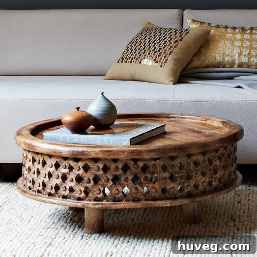 A close-up of a stylish carved wood coffee table with intricate detailing, inspiring a new design direction for the living room.