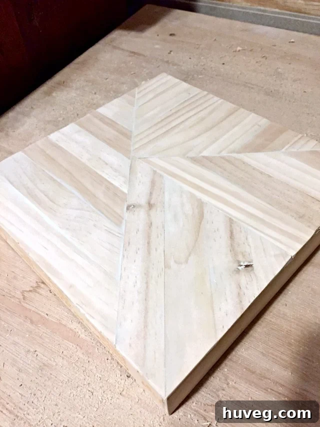 The paint stick art piece filled with an intricate pattern of unstained wood, ready for finishing.