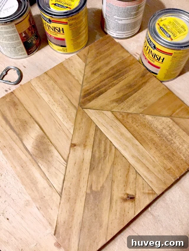 A beautifully stained wooden art piece made from paint sticks, showcasing the rich wood finish.