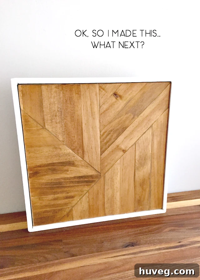 Close-up of the textured surface of the finished paint stick craft, highlighting wood grain and intricate pattern.