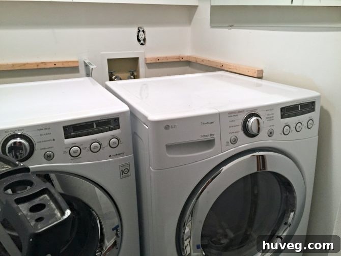 Functional laundry room with modern washer and dryer, showcasing efficient spacing and smart storage solutions