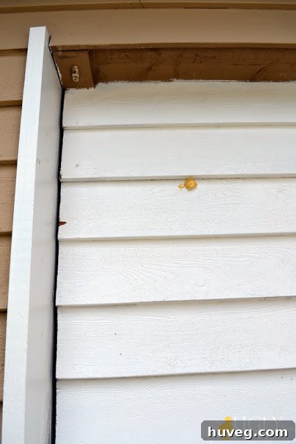 Close-up of the garage door hole before applying foam sealant