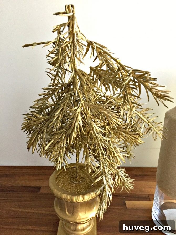 Small, old gold Christmas tree destined for repurposing