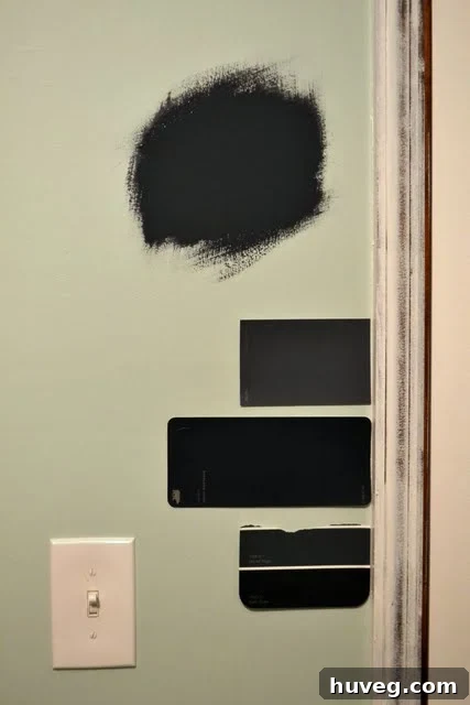 The room partially painted in a deep navy, showing the dramatic shift from teal.