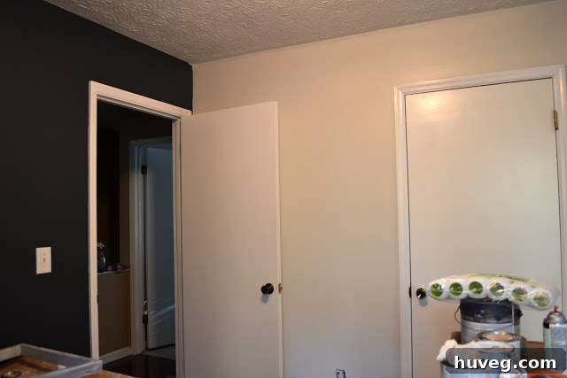 The study room walls partially painted with a light gray, which clashes with the navy.