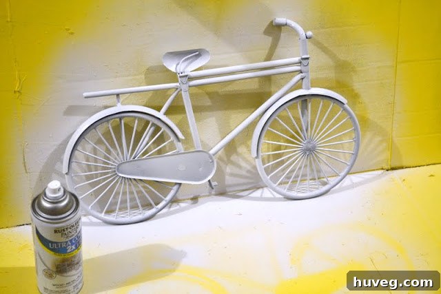 The decorative metal bike after being spray painted in a vibrant yellow.