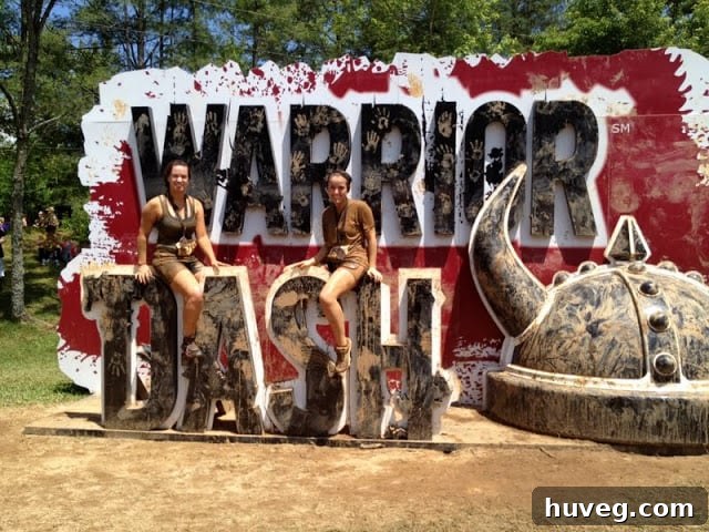 A Warrior Dash participant proudly showing off their mud-covered, muscled arm after finishing the race.