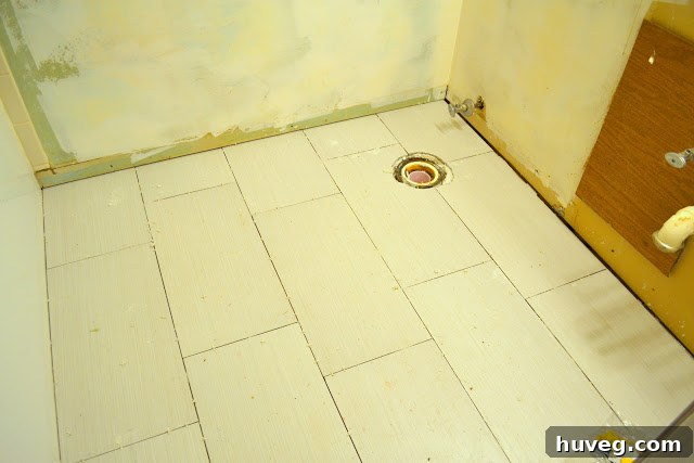 Bathroom floor with newly installed porcelain tiles awaiting grout