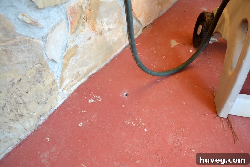 Front stoop with a noticeable hole before repair
