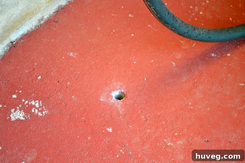 Detailed close-up showing a distinct hole in the concrete