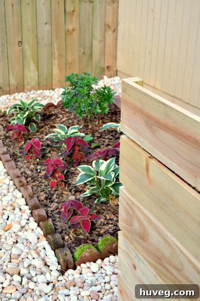Hidden air conditioning unit with decorative stones and foliage, improving curb appeal and maintaining efficient airflow.