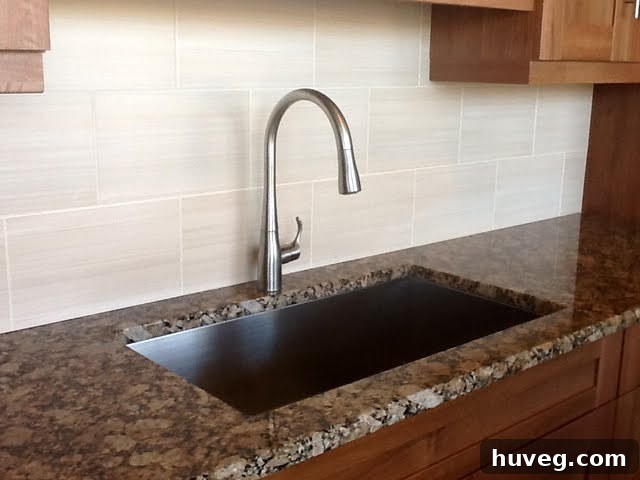 Large tile backsplash and sleek sink