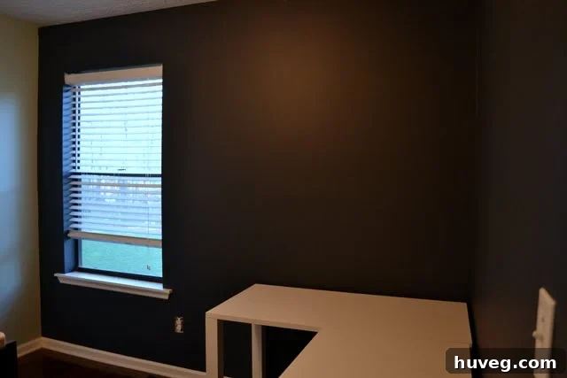 Close-up view of the Benjamin Moore Hale Navy paint on a study wall, showcasing texture and color depth