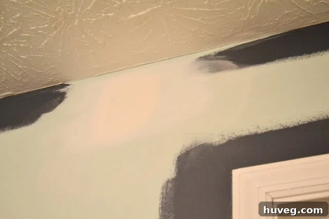 Newly sanded and primed ceiling patch after a late-night DIY session