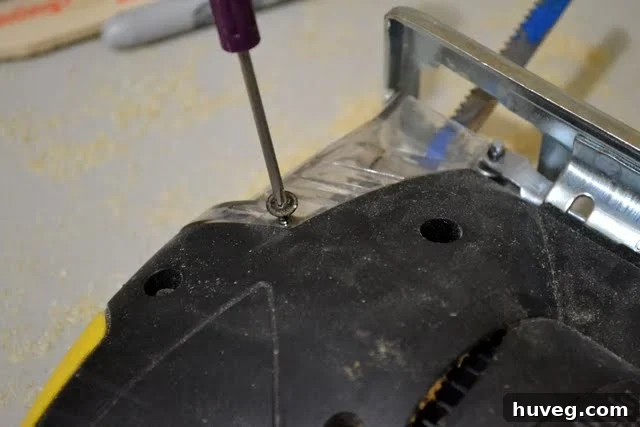 Unscrew the blade guard or cover to access the jigsaw blade clamp