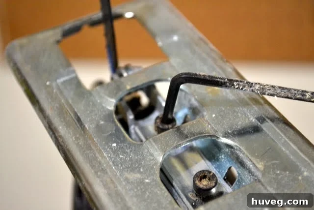 Use an Allen key or hex wrench to loosen the jigsaw blade clamp screws