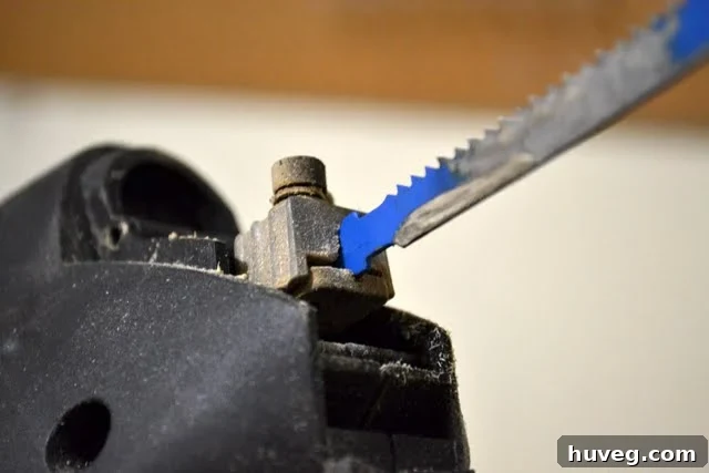 Carefully release the old blade from the jigsaw clamp