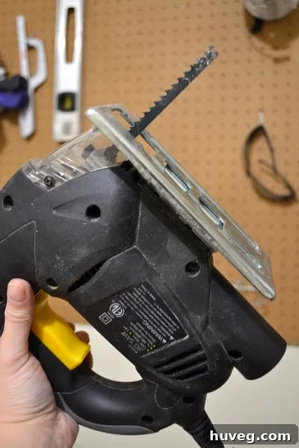 Insert the new jigsaw blade into the clamp and tighten securely