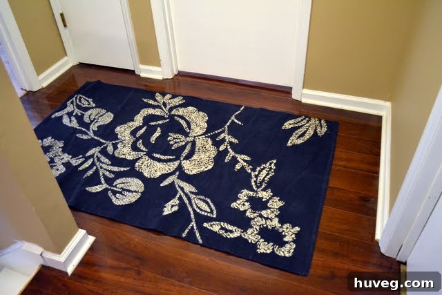 Bright and clean upstairs hallway with freshly caulked baseboards and a non-slip rug