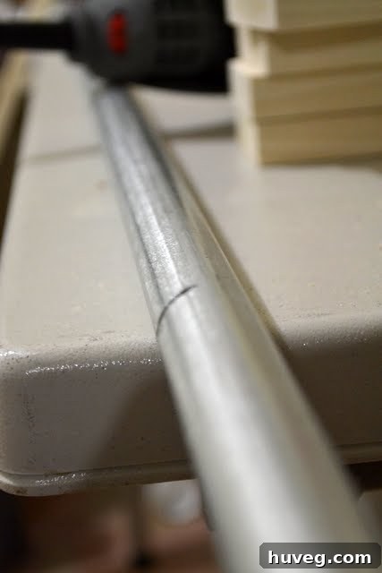 Close-up of a small slice being made in metal pipe