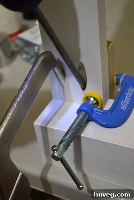 Partial view of the DIY desk frame from below, highlighting structural supports and sturdy construction.