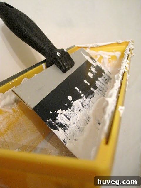Bathroom walls after wallpaper removal and during skim coating process