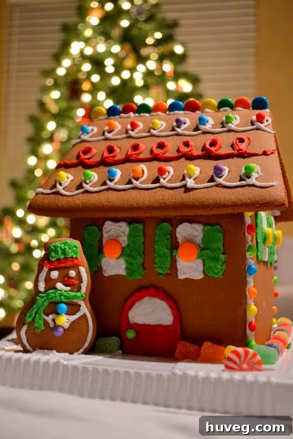 Finished gingerbread house decorated with various candies and icing