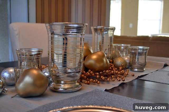Wider view of an exquisite Christmas dinner table, beautifully decorated with candles, greenery, and metallic touches, ready for holiday guests.
