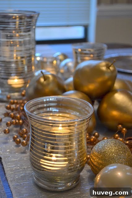 Detailed shot of a silver and gold centerpiece on a Christmas table, showcasing ornaments and delicate decorations.