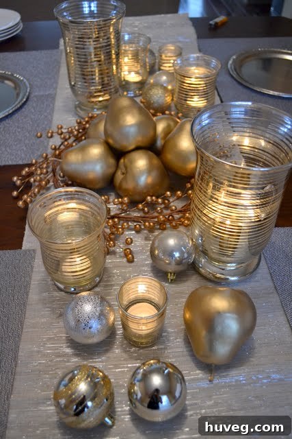 Table setting featuring a mix of silver and gold decor elements, including candle holders and festive baubles, capturing the ambient light.