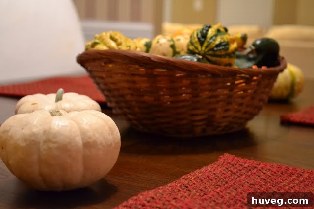 Close-up of a hand holding a patterned decorative gourd