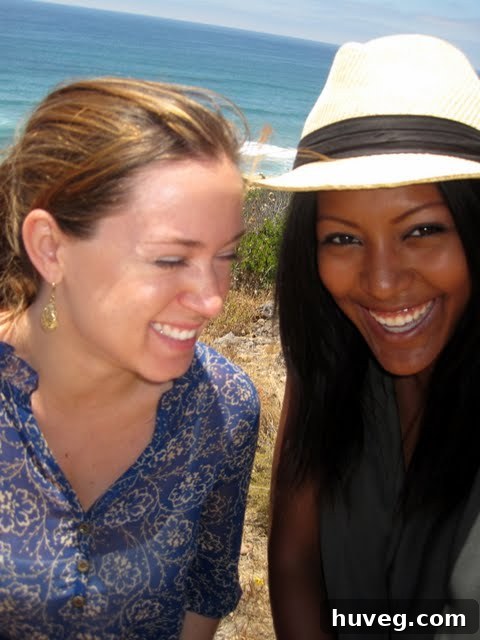 Two friends smiling happily at a scenic coastal viewpoint in beautiful La Jolla, California