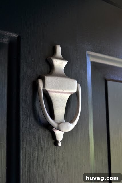 Close-up of newly painted door knocker and house numbers