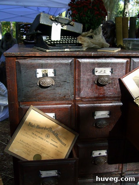 A collection of antique tools and rustic farm implements