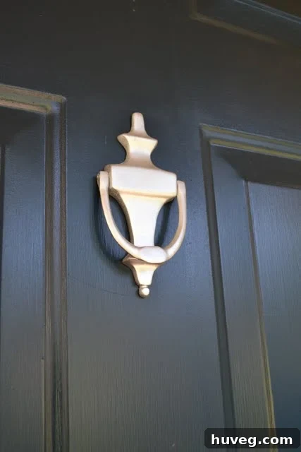 Close-up view of a meticulously painted door knocker after its DIY renovation, appearing brand new