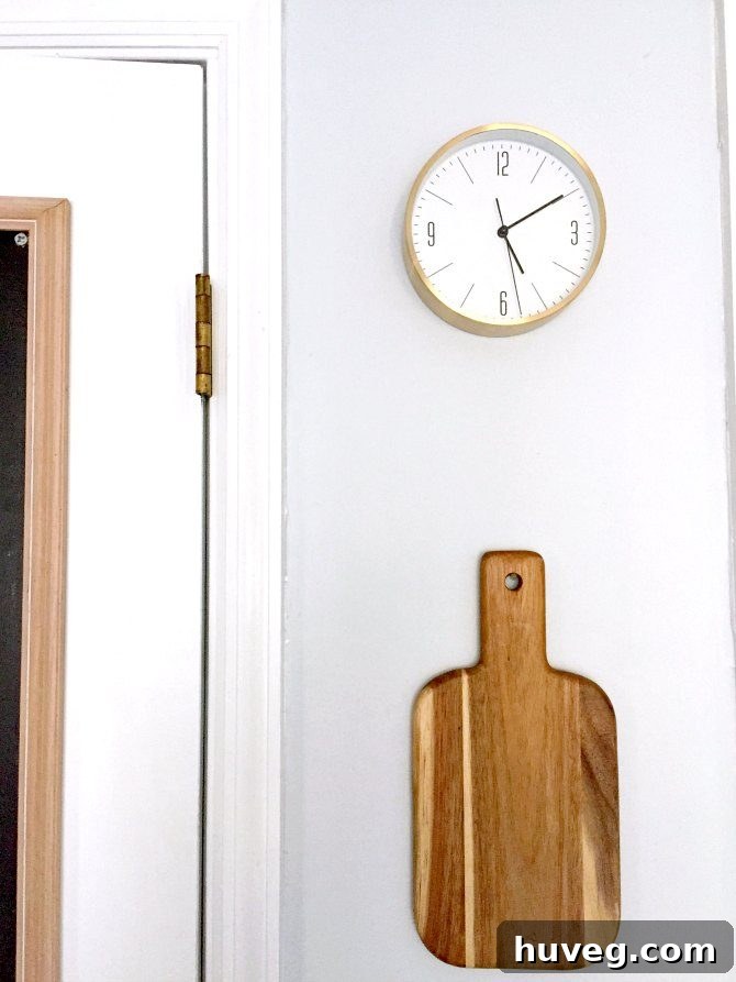 Stylish brass wall clock and cutting board as decorative wall art, reflecting modern home decor trends for a minimalist aesthetic.