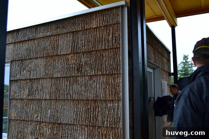 Unique bark siding as a green alternative for exterior finishes on a sustainable home design at Solar Decathlon