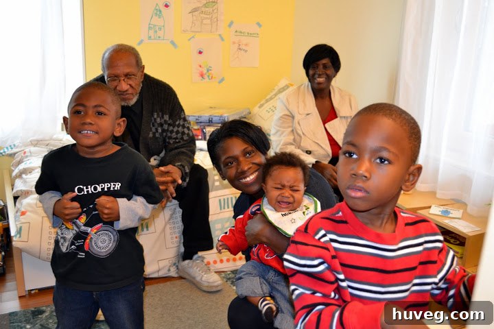 Happy Habitat for Humanity family beginning to make their new Solar Decathlon house a home, symbolizing accessible green housing