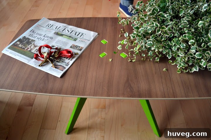 Stylish midcentury coffee table with exposed lime green legs incorporated as a decorative inlay, showcasing innovative furniture design