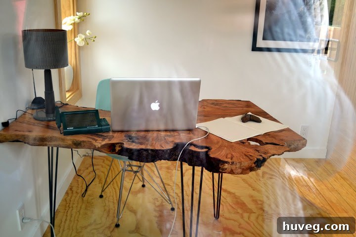 Beautiful live edge wood slab desk with midcentury iron legs, showcasing natural modern furniture in a sustainable home