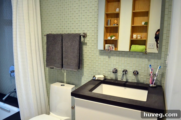 Modern bathroom featuring green vertical glass mosaic subway tiles, an emerging trend in sustainable home design