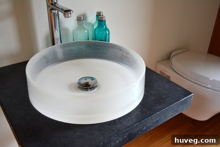 Stylish bathroom with a stained concrete counter and vessel sink, highlighting sustainable and modern interior design